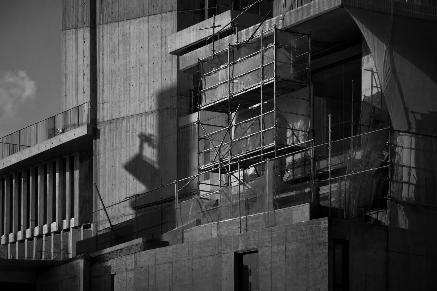 Concrete facade under scaffolding during renovation