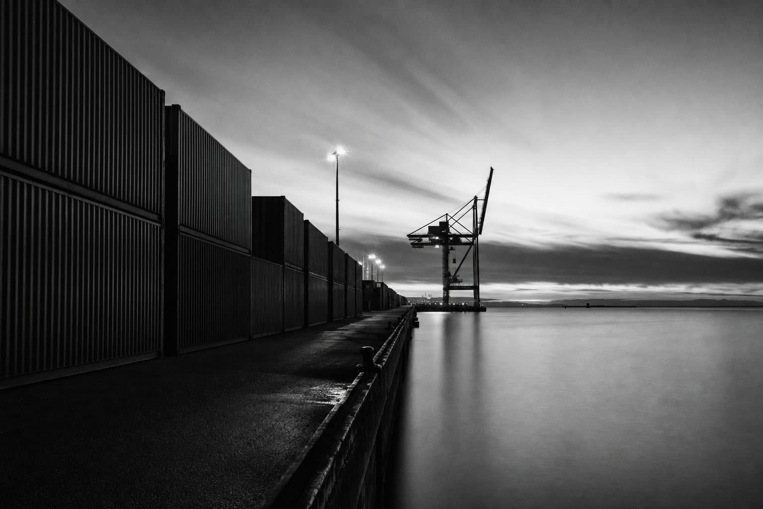 Seaport with rows of containers at dusk